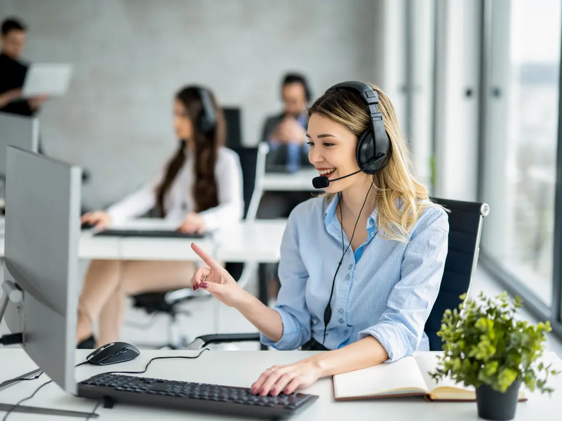 Support specialist with a headset at a workstation